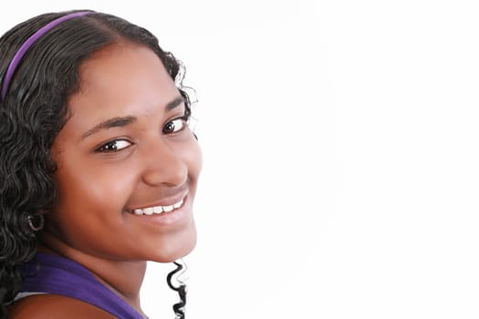 Beautiful smiling face of a happy African teenager girl, isolated.