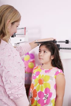 Doctor measure little child girl height growth