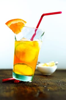 Glass of summer cocktail with orange and tubule