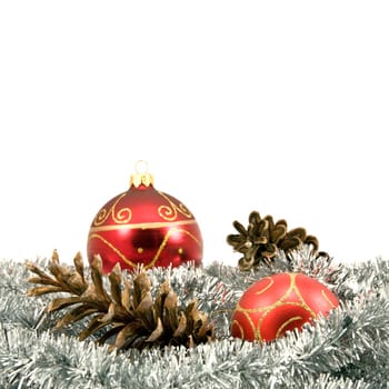 garland with pine cones and baubles over a white background