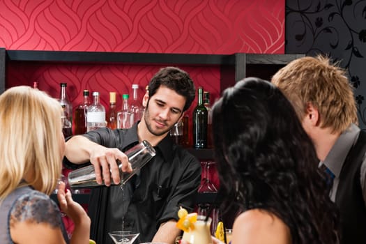 Young barman prepare drink friends at cocktail bar