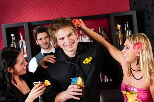 Friends drinking at cocktail bar during happy hours have fun