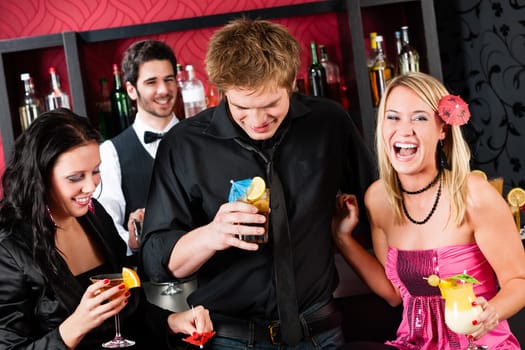 Cocktail bar laughing friends having fun at party time