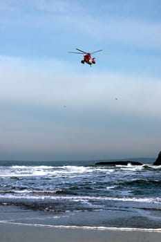 a sea rescue helicopter searching for person near to the cliffs on search and rescue mission in ballybunion county kerry ireland