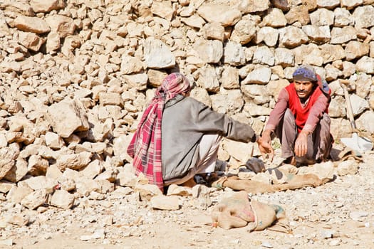 Shiva Kodi, Kashmir, India - December 18, 2011: Editorial, portrait of wall builders along the public foot path to Shiv Kodi hindu temple trying to work out who should gather rocks and who will carry, photograph, rendition, vtwo