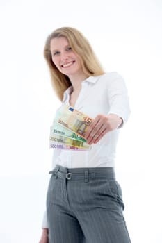 Businesswoman showing many different banknotes to the front and smiling-in front of white background-