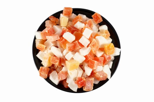Black bowl full of dried papaya and coconut