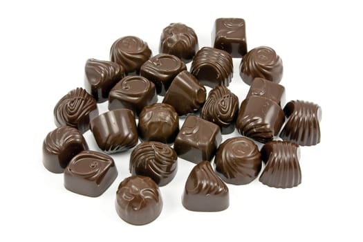 dark assorted chocolate pralines on white background