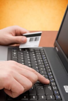 e-commerce concept. hands with credit card on computer keyboard