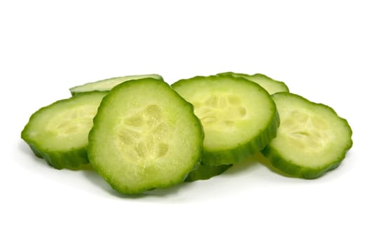 green cucumber slices over a white background