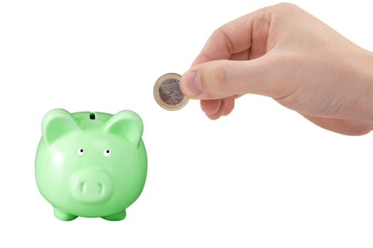 hand putting coin to the green piggy bank