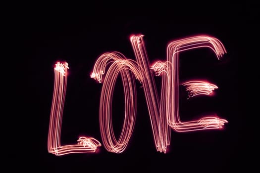 the word "LOVE"" written with light"