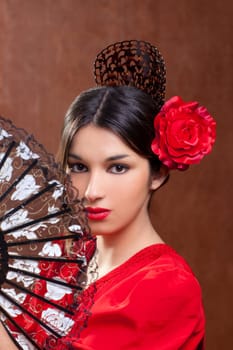 Gypsy flamenco dancer Spain girl with red rose spanish hand fan and peineta comb