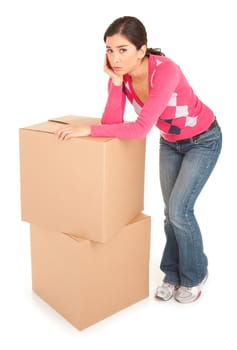 A tired looking woman is leaning on cardboard boxes.