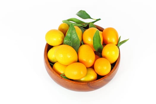 kumquat midget orange in wooden bowl isolated on white