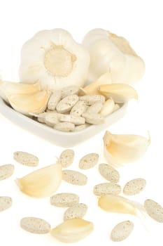 Garlic and herbal supplement pills isolated, alternative medicine concept