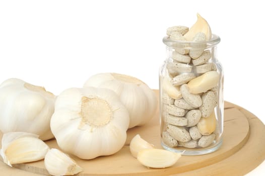 Garlic and herbal supplement pills isolated, alternative medicine concept