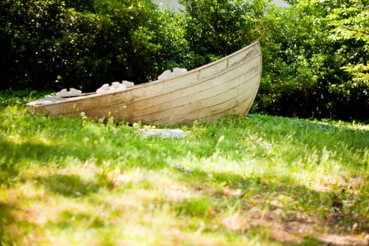 Wooden boat on grass in the park
