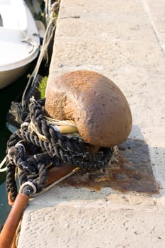 Ship pier bollard with rope