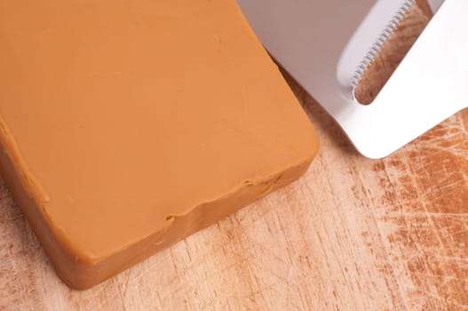 Close-up of Norwegian Gundbrandsdalen Norgold cheese with cheese slicer