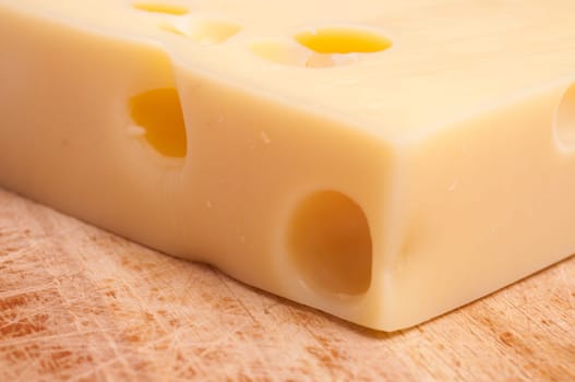 Swiss Emmental cheese and wooden board