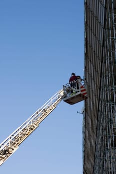 Photo of Firemans on crane