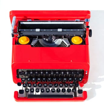 Old red typewriter isolated on a white background