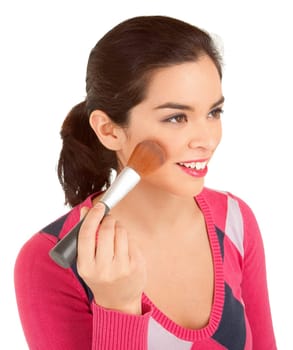Close-up of a young woman powdering her cheek.