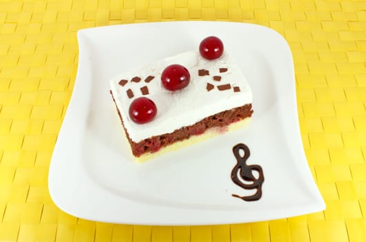 Sweet homemade cake with sour cherries on white plate