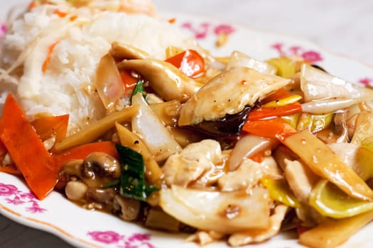 A delicious asian chicken with vegetables and white rice