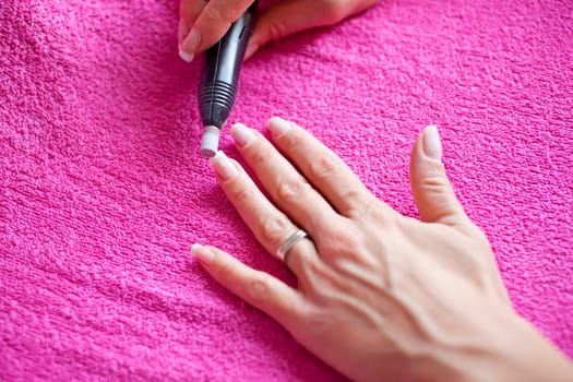Womans hand getting a professional manicure