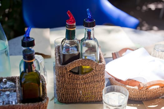 Vinegar and oil inside a wicker basket