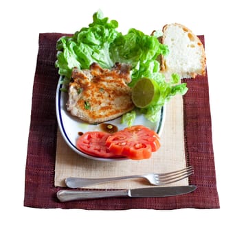 Breaded steak and salad with lettuce and tomato
