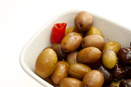 Olives inside a saucer on white background