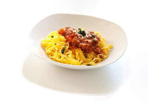 Italian pasta with ragout sauce on white background