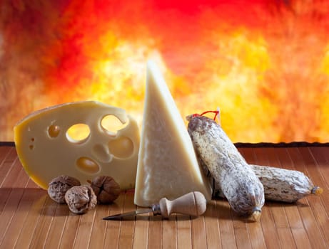 Italian cheese and salumi on a orange background