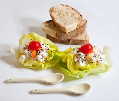 Bread and fresh salad on white