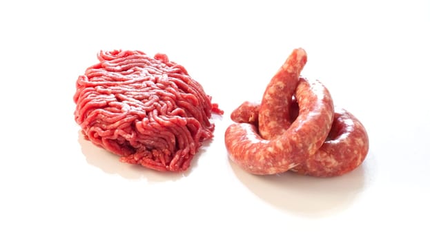 Sausage and meat pincer on white background