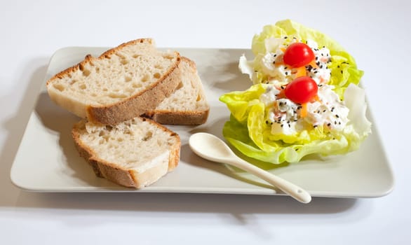 Bread and fresh salad on white