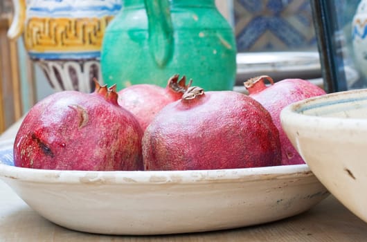 Pomegranates inside a ceramic dish