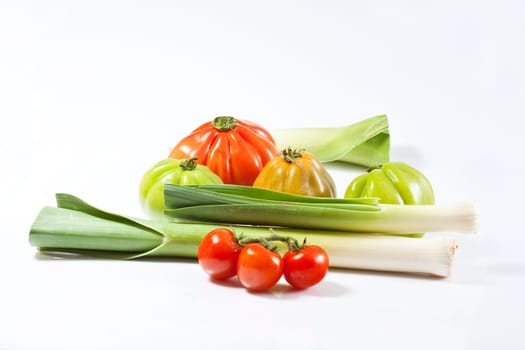 Leeks and tomatoes isolated on a white background