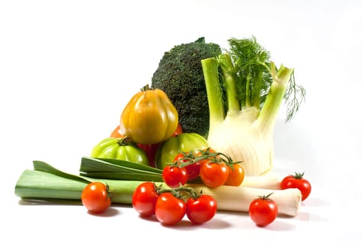 Leek, fennel, broccoli, and tomatoes isolated on a white background