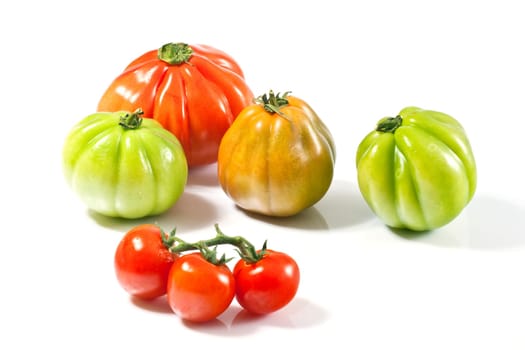 Various fresh tomatoes on a white background