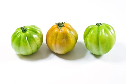 Various fresh tomatoes on a white background