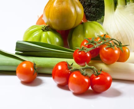 Leek, fennel, broccoli, and tomatoes isolated on a white background