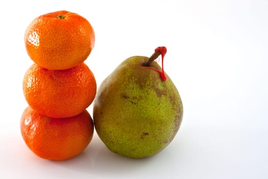 Decana pear and tangerines on white background
