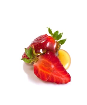 Strawberries and honey on white