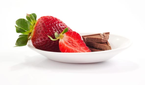 Strawberries and chocolate on saucer