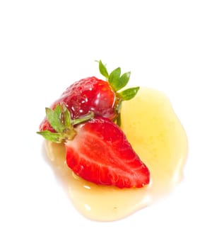 Strawberries and honey on white