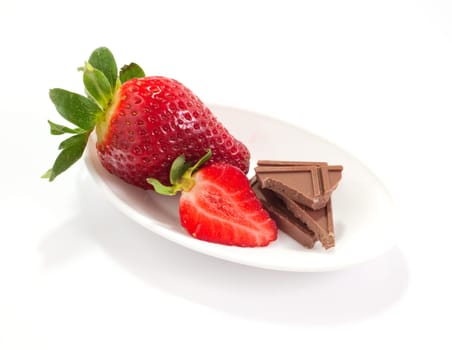 Strawberries and chocolate on saucer